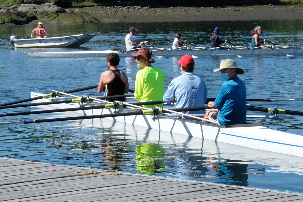 Adult rowers approaching the dock.