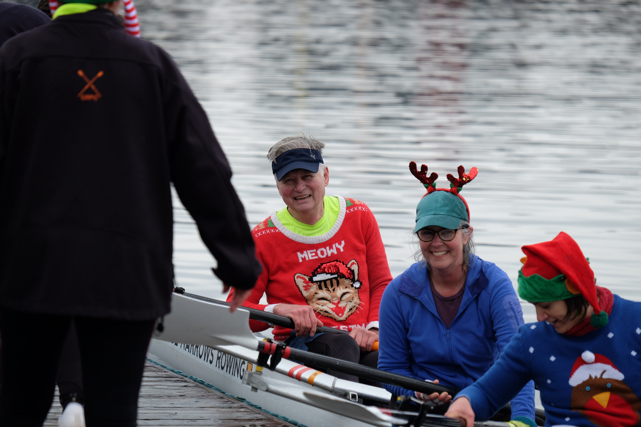 A quad docking with three festively dressed rowers visible.