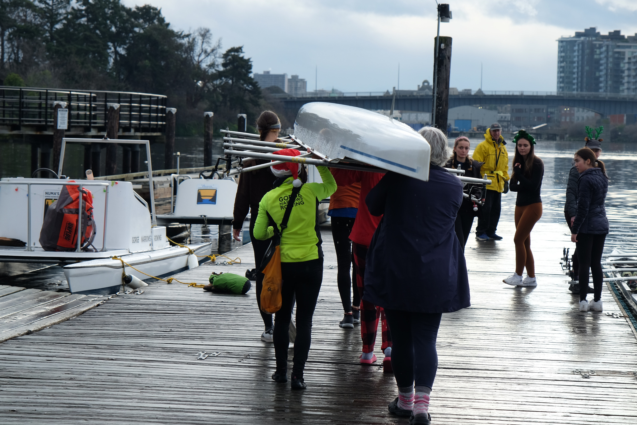 Rowers carrying a quad off the dock.