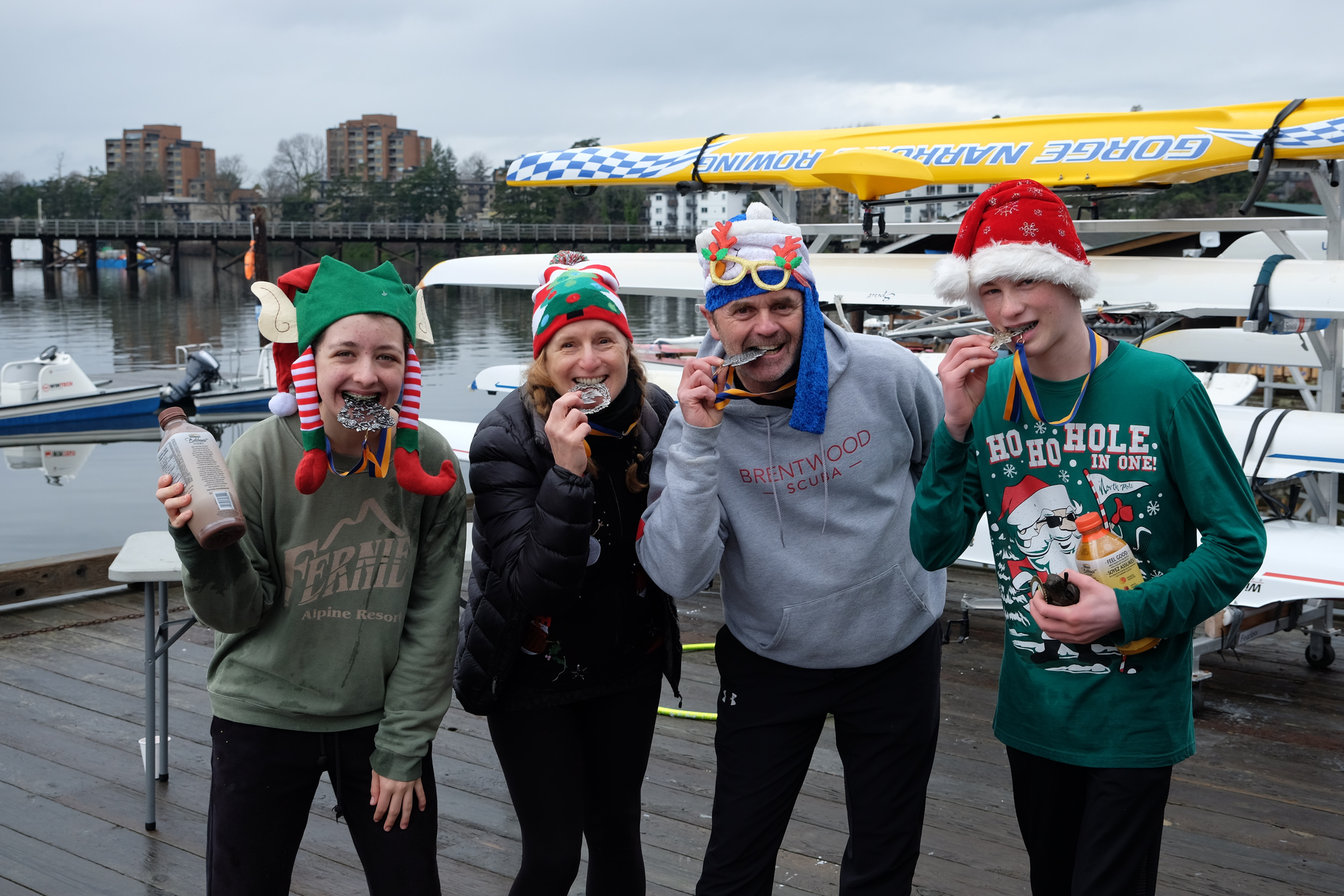 The first place team mugging it up by pretending to bite their medals.