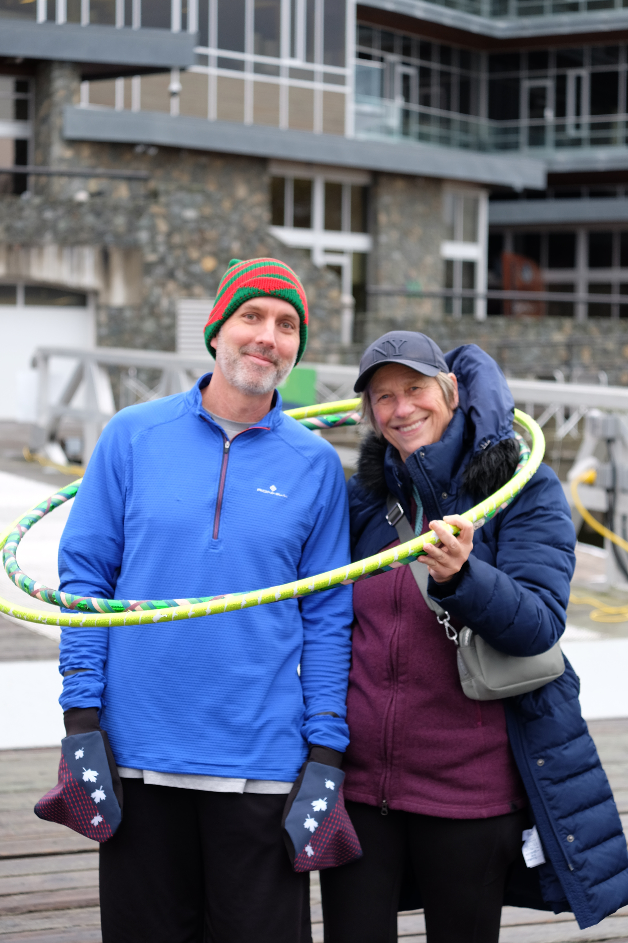 Two rowers posing in a pair of hula hoops.