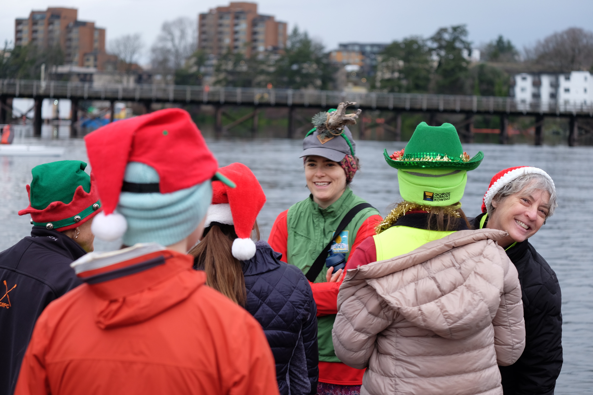 People gathered on the dock. All are wearing festive holiday hats.