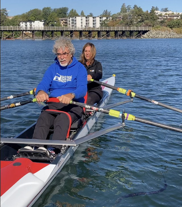 A member of our adaptive program rowing a double with our club manager.