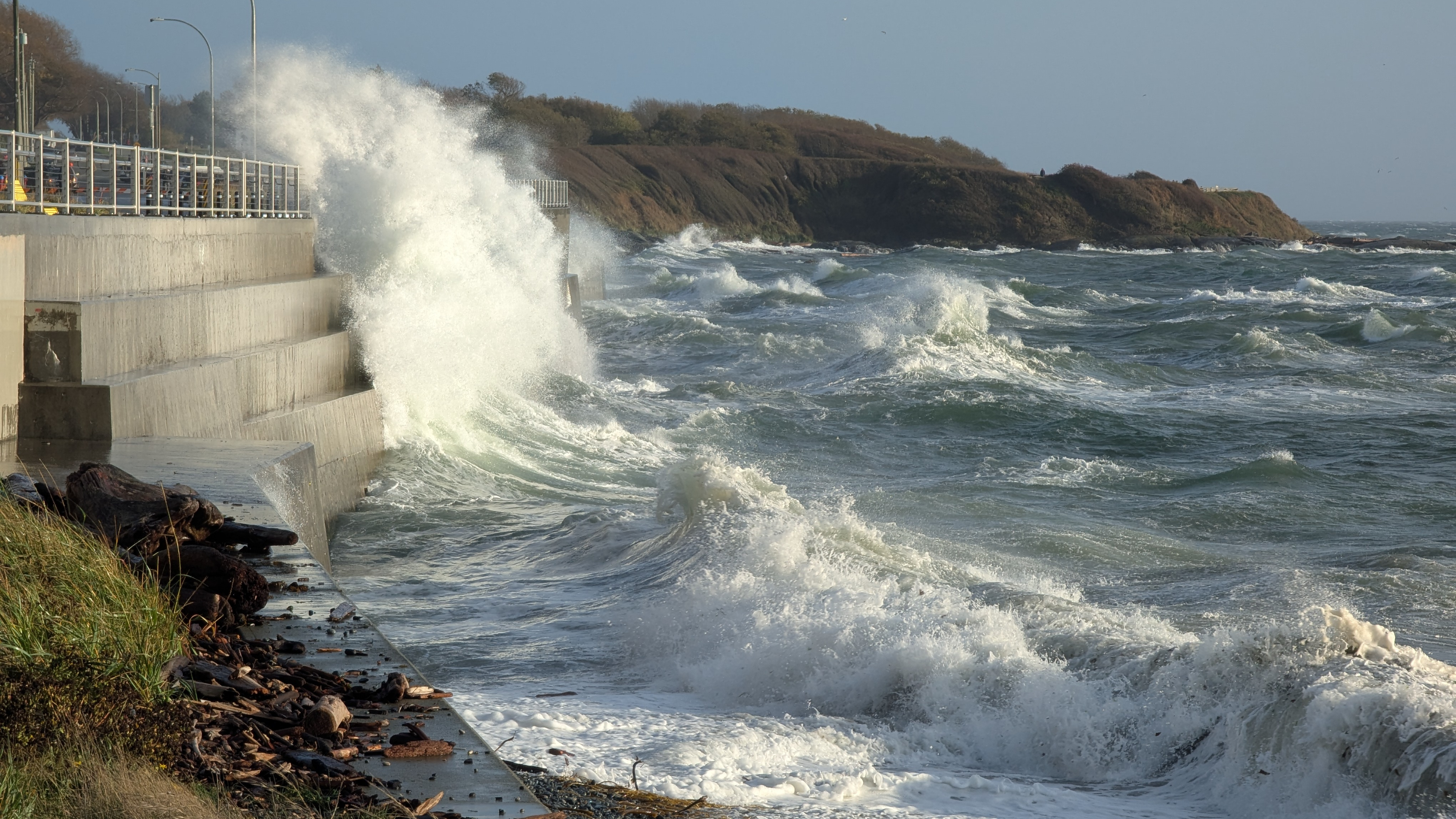 Waves crashing onto the path by Dallas Road near the Breakwater in Victoria, BC.