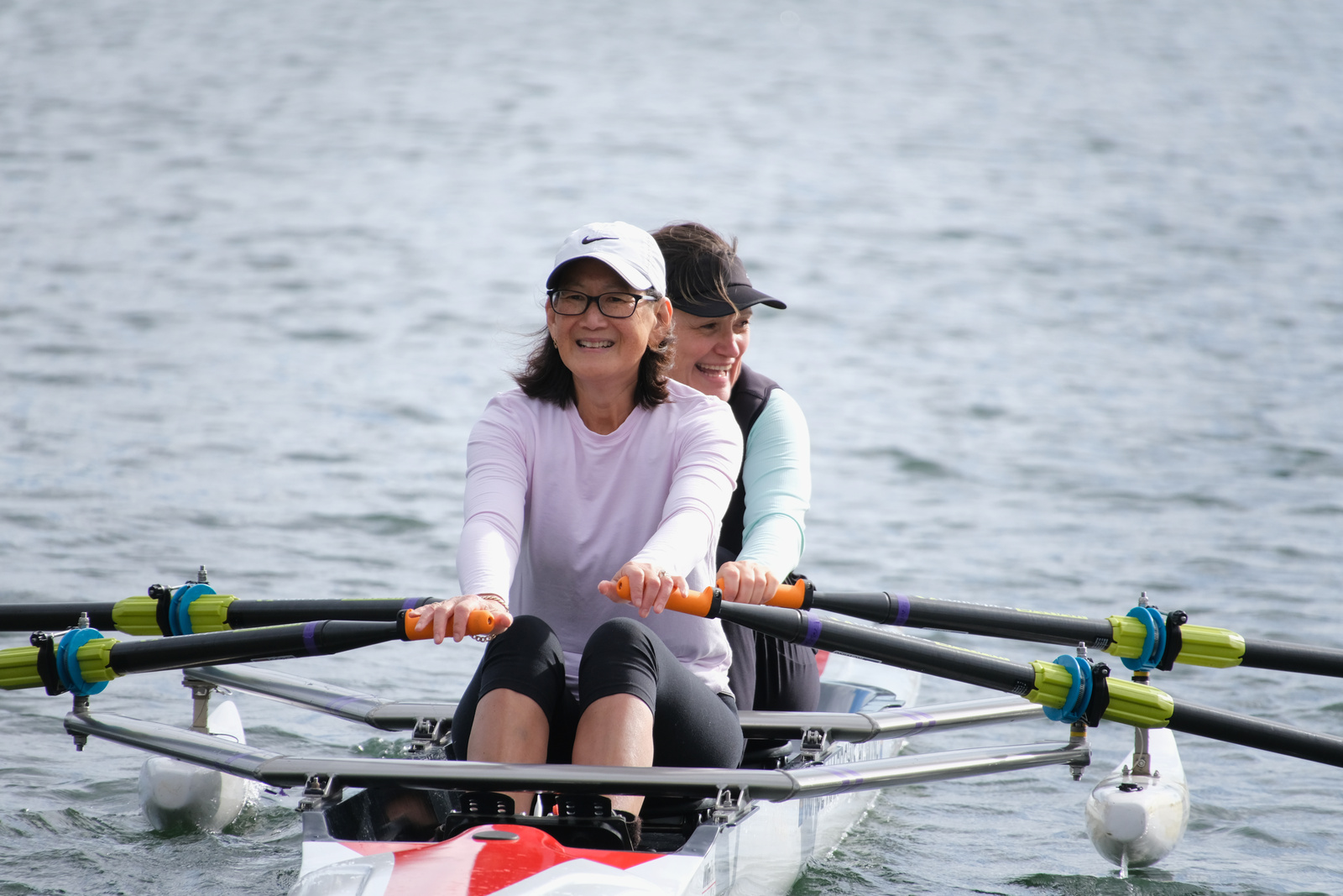 Two adult rowers on the water.