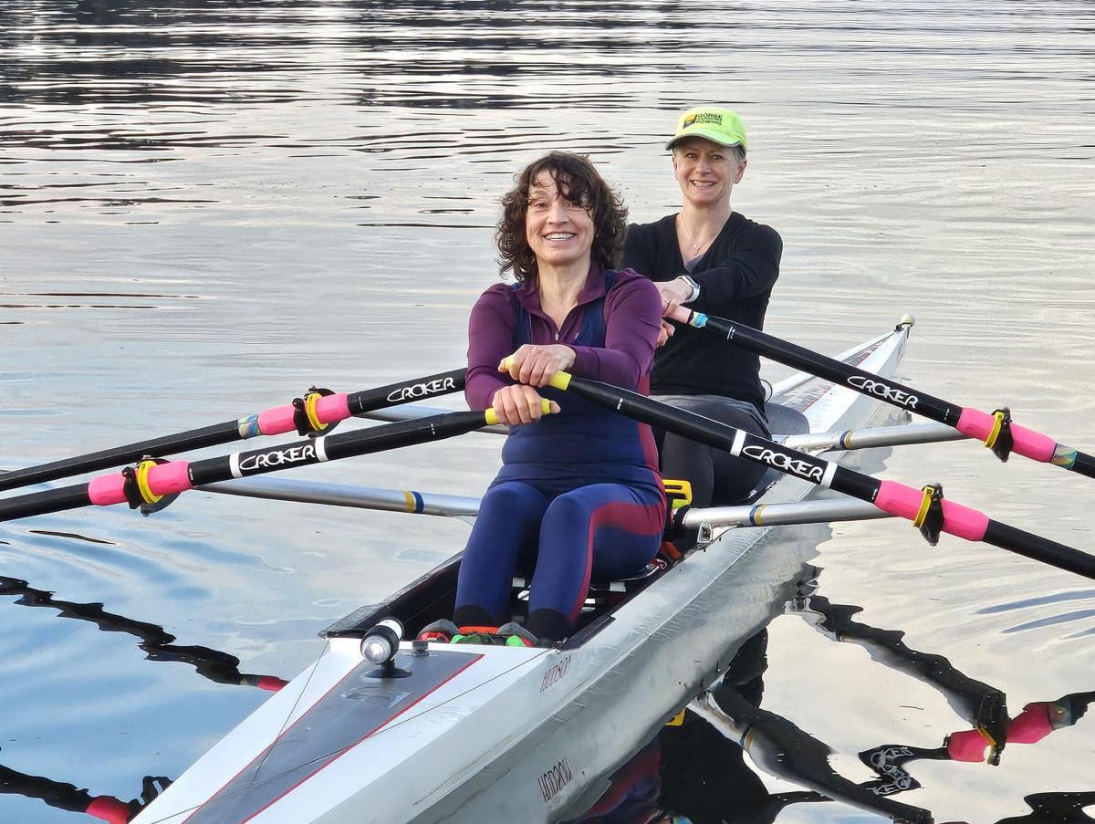 Two adult rowers on the water.
