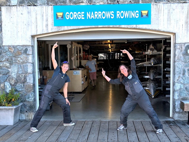 The boathouse door. Two coaches are pointing at the 'GORGE NARROWS ROWING' sign.