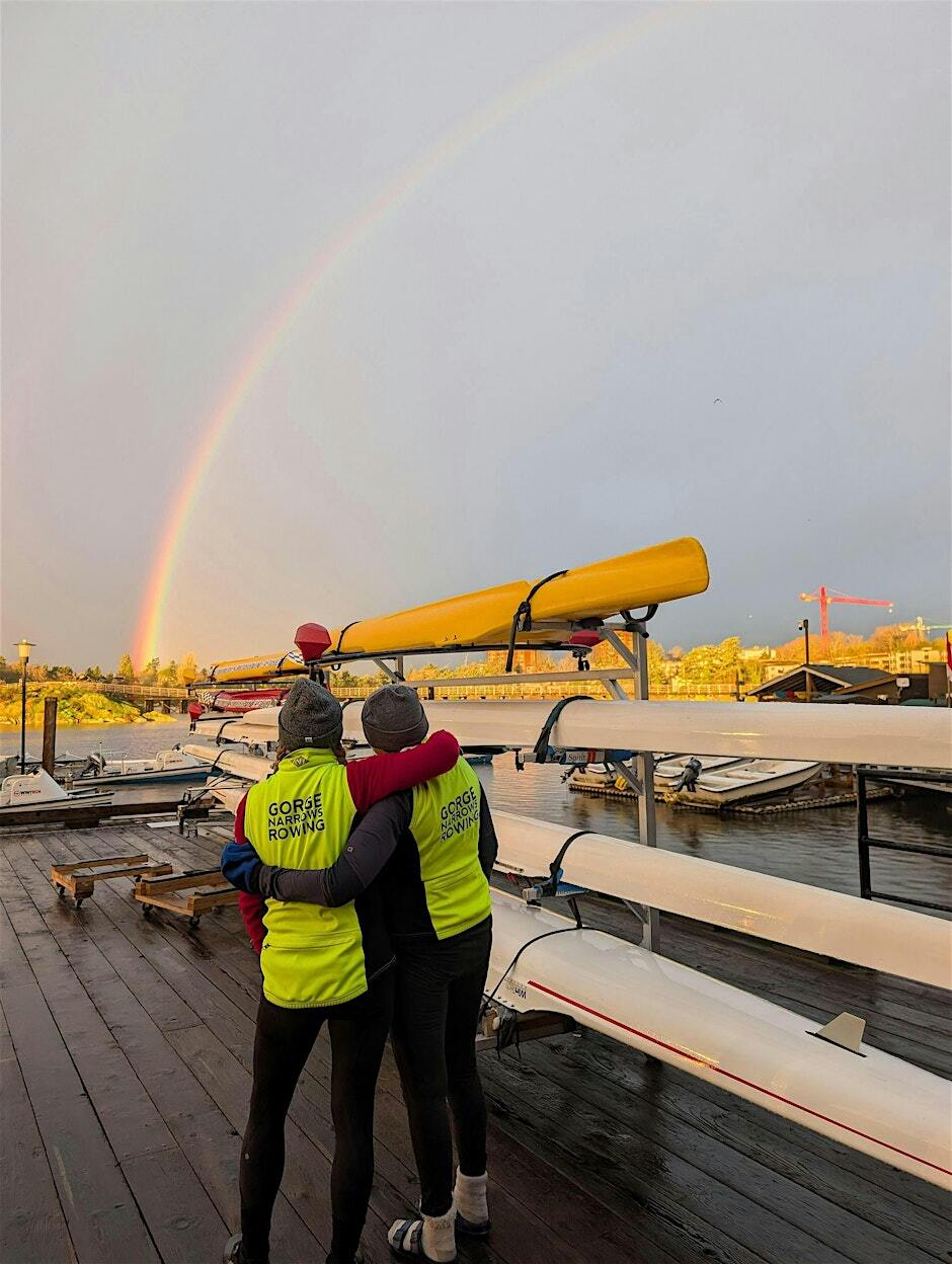 Two rowers watch a rainbow at the GNRC dock.