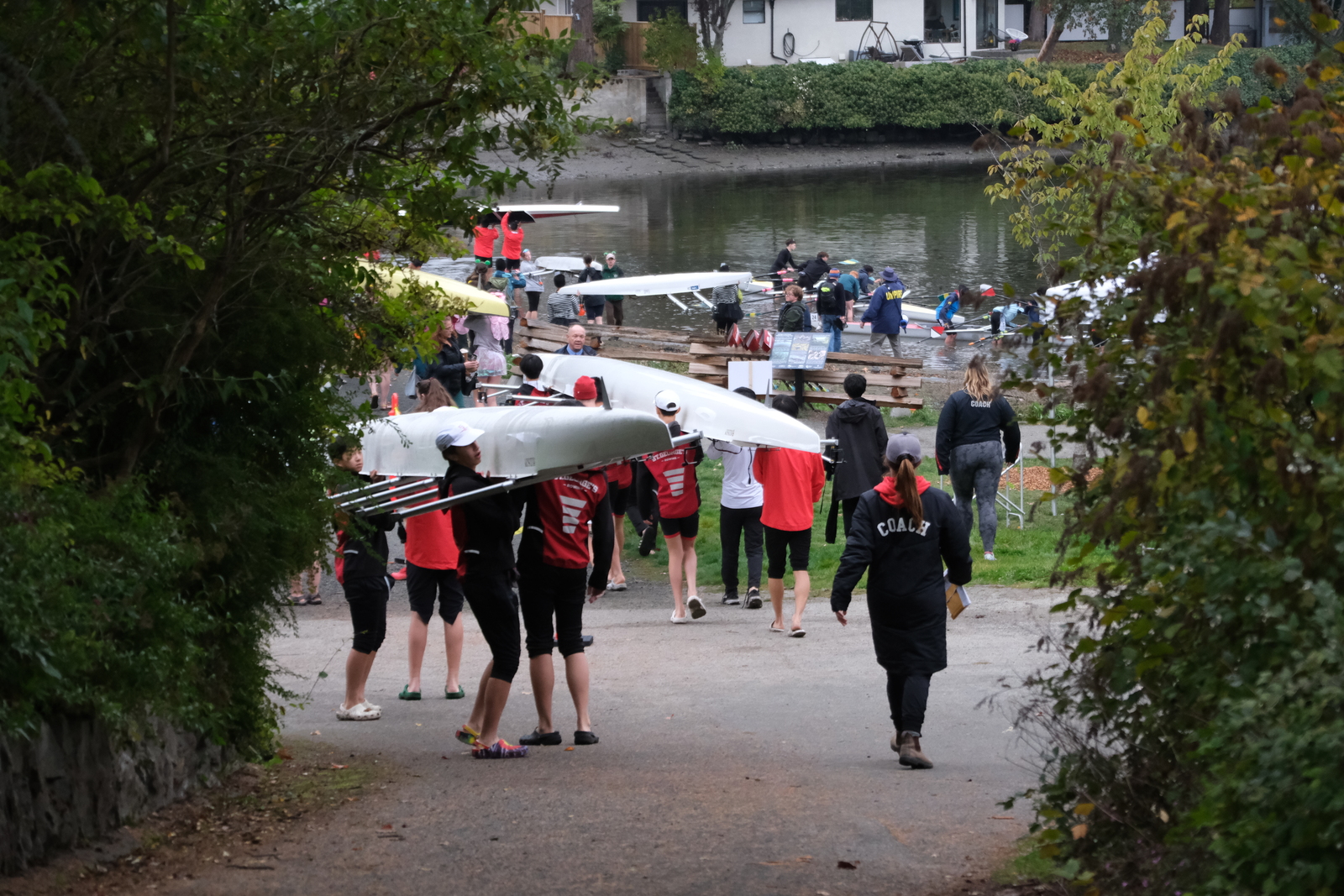 Rowers carry boats down to the water at the 2025 HOG-TOG.