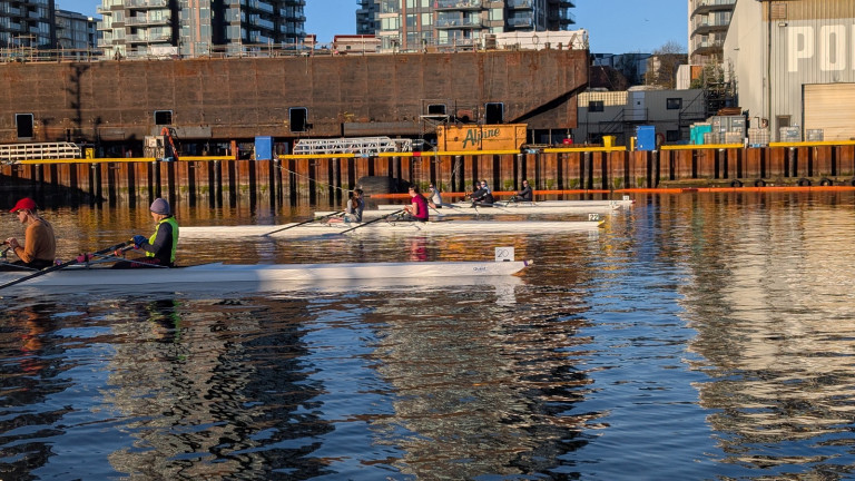 Four quads get ready for the start in front of the shipyard.