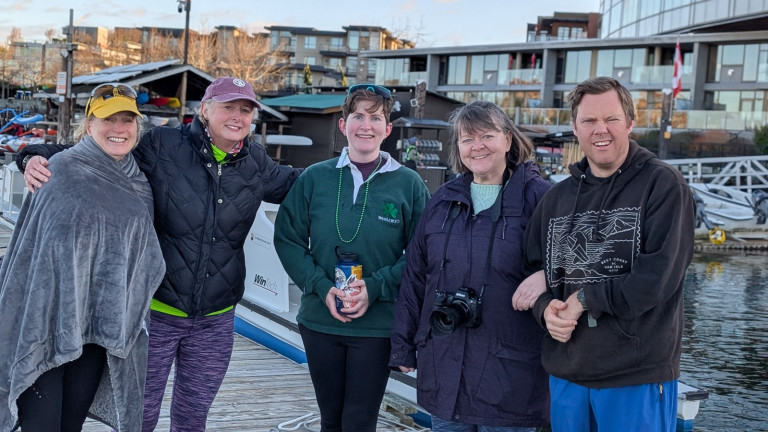 Rowers staying warm on the dock.