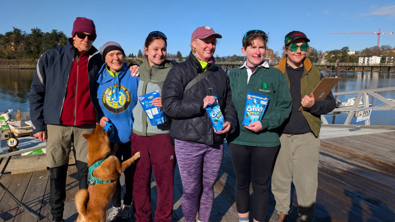 Yet another four rowers and a coach on the dock after receiving their prizes!