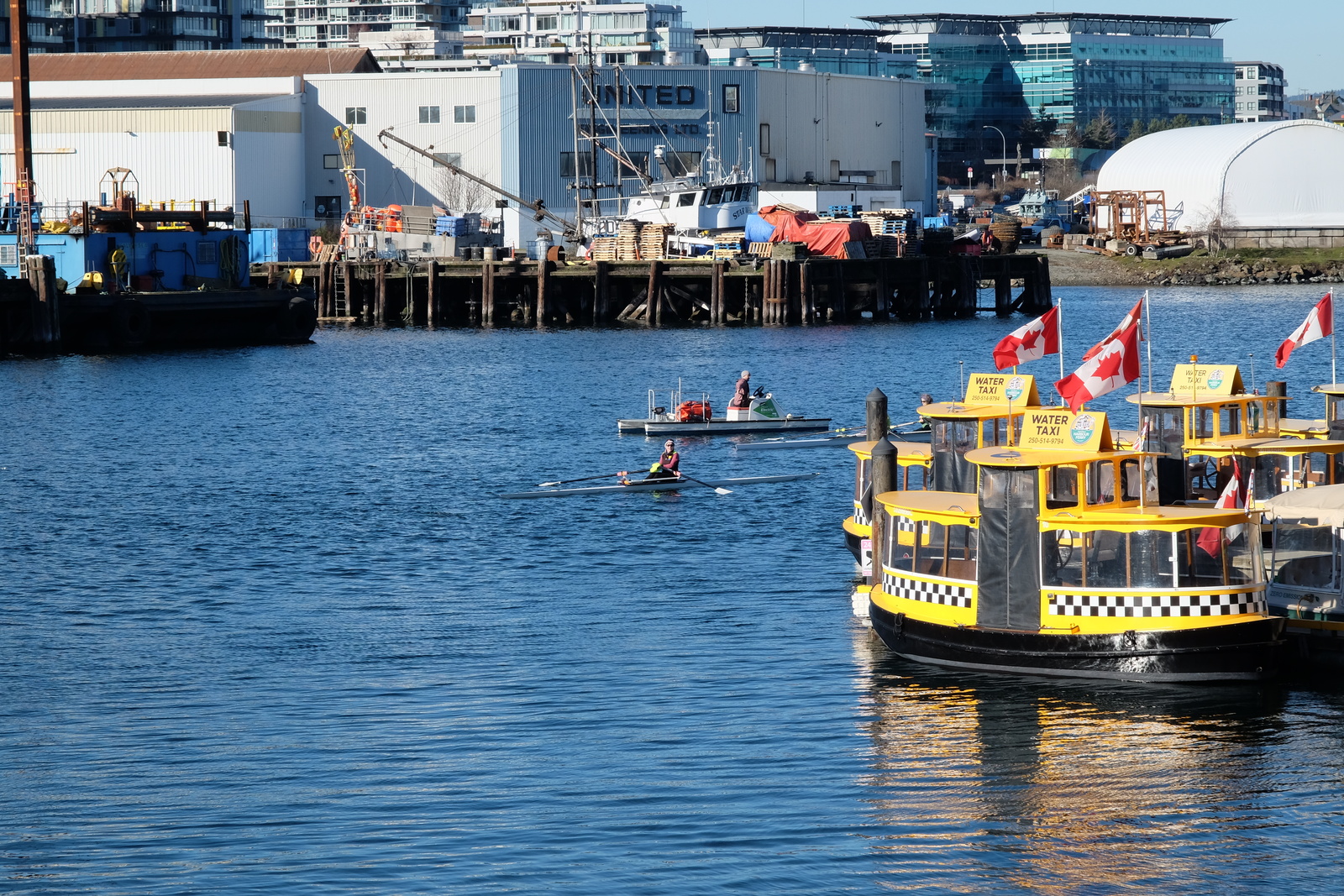 A single and coach boat near the water taxis.